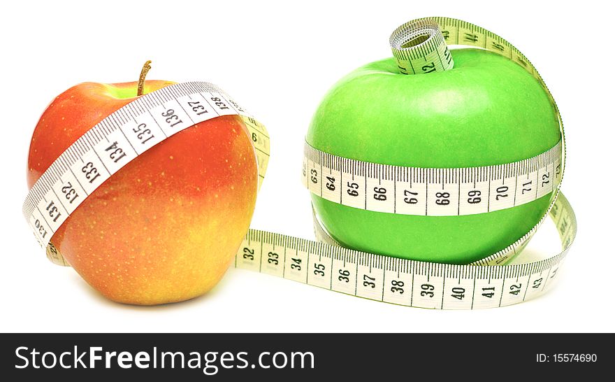 Tape measure wrapped around green and red apple isolate on white