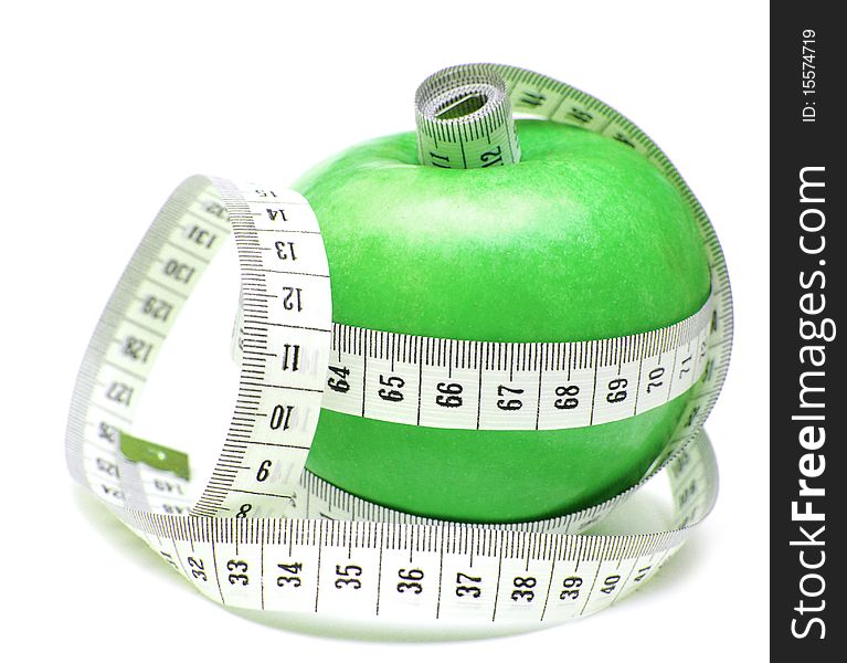 Tape measure wrapped around green apple