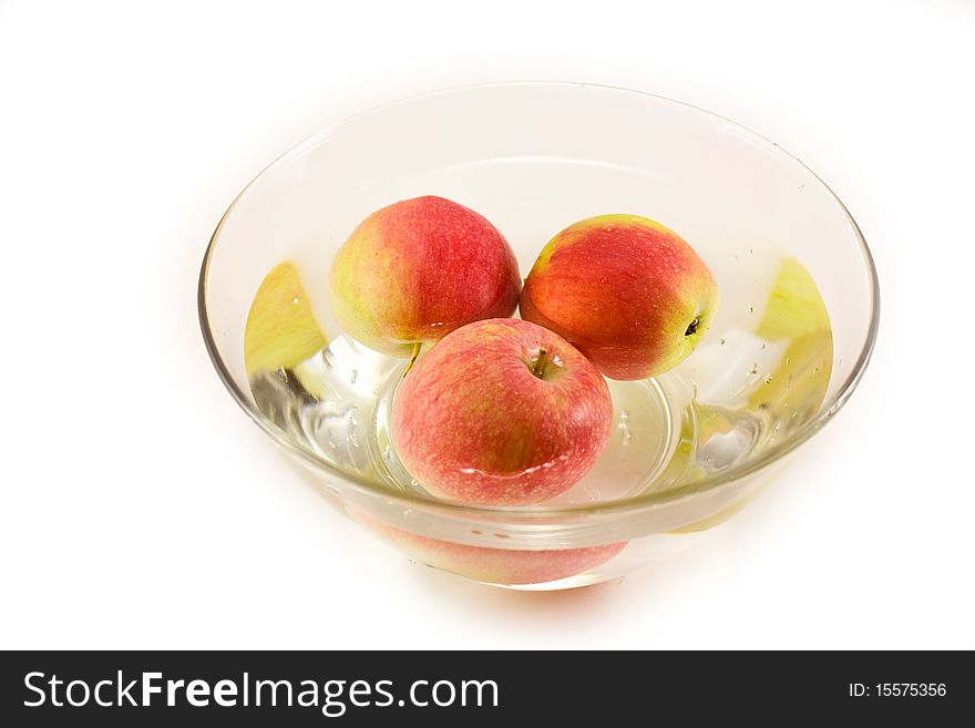 Ripe apples floating in a bowl with water. Ripe apples floating in a bowl with water