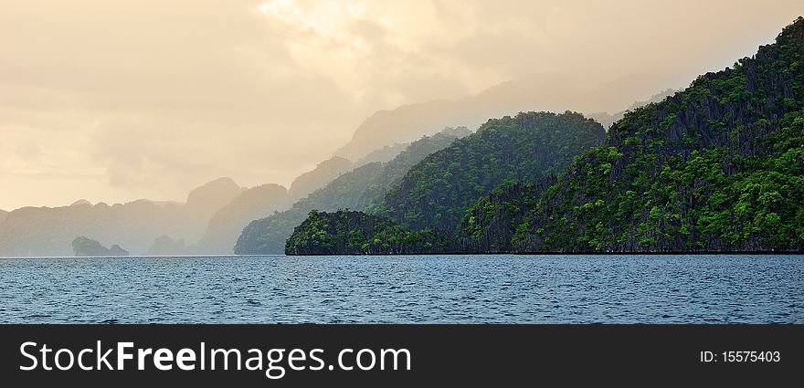 A mist covers the black island in Coron right after a short rainshower. A mist covers the black island in Coron right after a short rainshower.