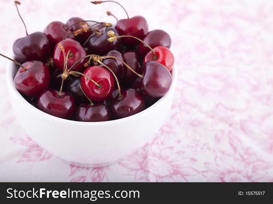 A white bowl of cherries