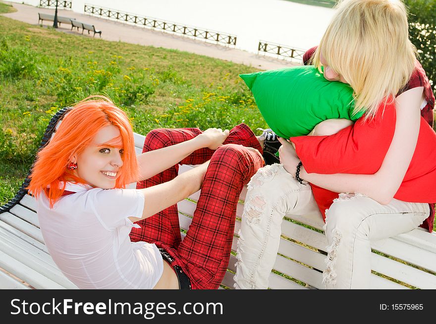 Two teenage girls have fun at the summer park. Two teenage girls have fun at the summer park