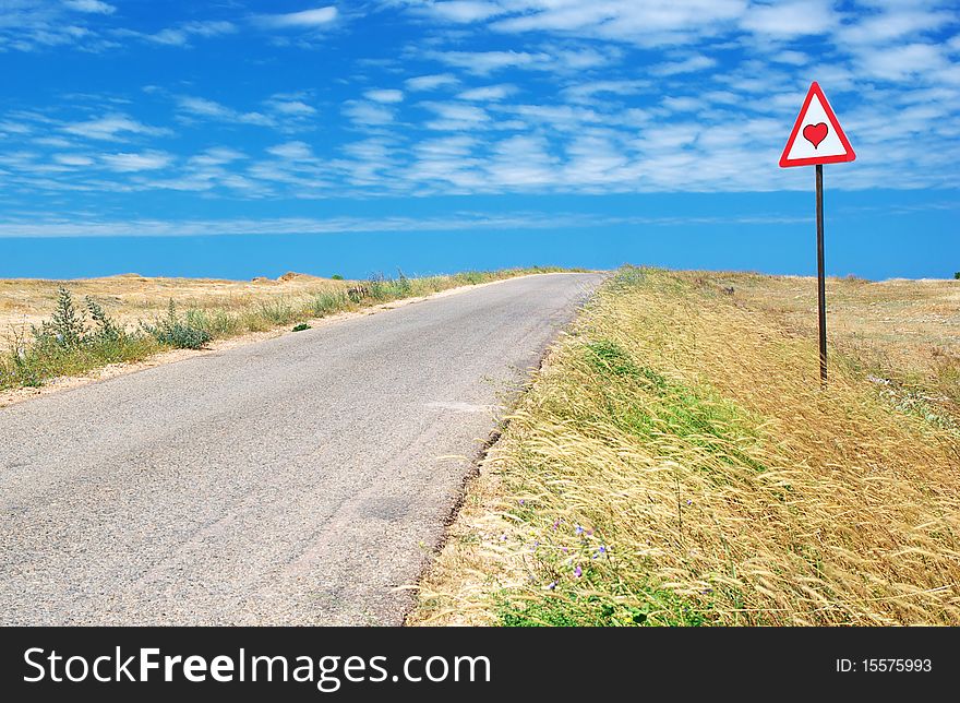 Road in desert and traffic sign. Nature composition.