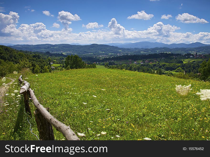 Landscape Mountains hills and meadow and blue cloudy sky