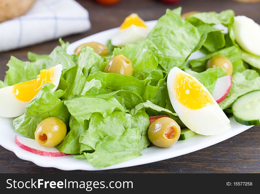 Close up of freshly made salad with lettuce,eggs and olives. Close up of freshly made salad with lettuce,eggs and olives
