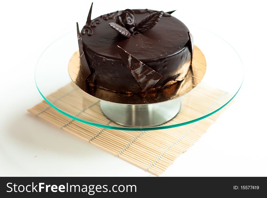 Chocolated cake on isolated background with rose and petals. Chocolated cake on isolated background with rose and petals