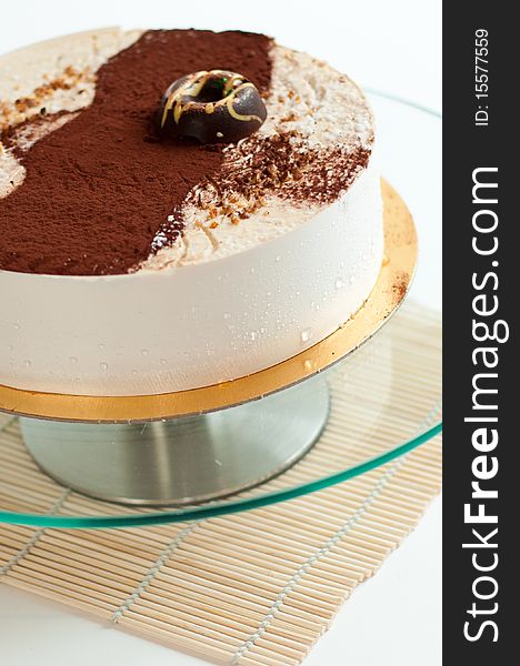 Cream cake on isolated background on glass plate. Cream cake on isolated background on glass plate