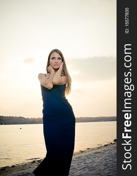 Woman In Dark Dress In The Beach