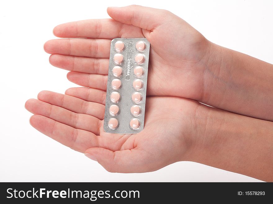 Pink medical pills container on a female hand, 

isolated