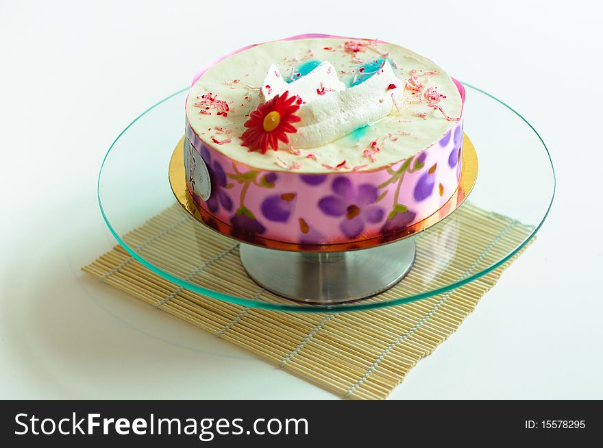 Cream cake on isolated background on glass plate. Cream cake on isolated background on glass plate