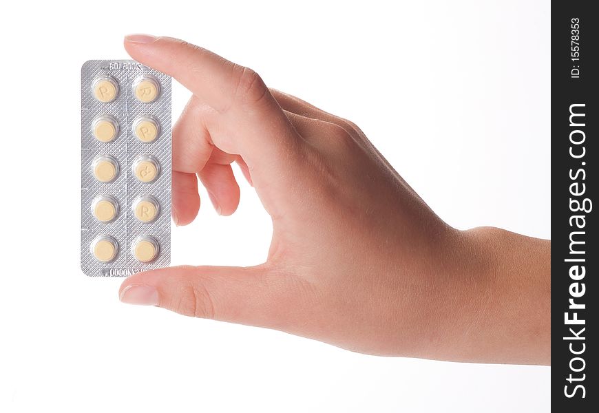 Medical pills container on a female hand, isolated on white