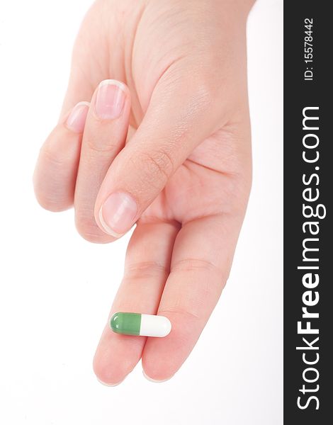 Green Medical Capsule In A Female Hand, Isolated