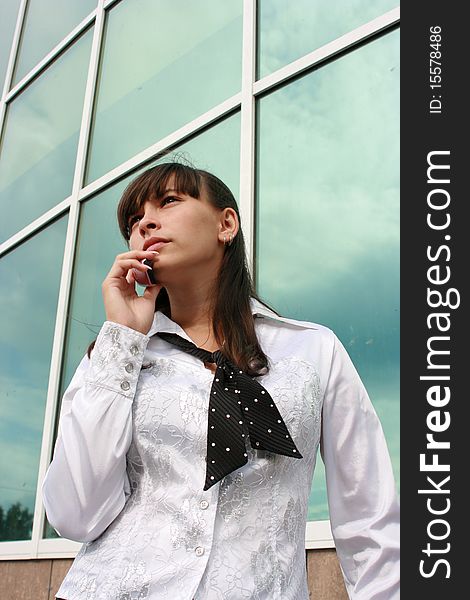 Businesswoman calling by phone outdoors