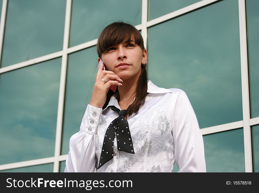 Businesswoman calling by phone outdoors