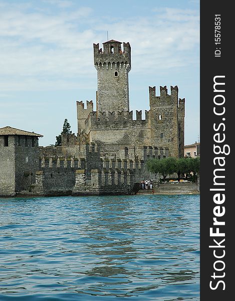Italy, lake of gardy, blue wonderfull water and ancient building, summer, july. Italy, lake of gardy, blue wonderfull water and ancient building, summer, july