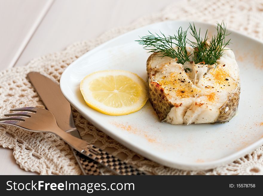 Baked cad served with lemon and dill