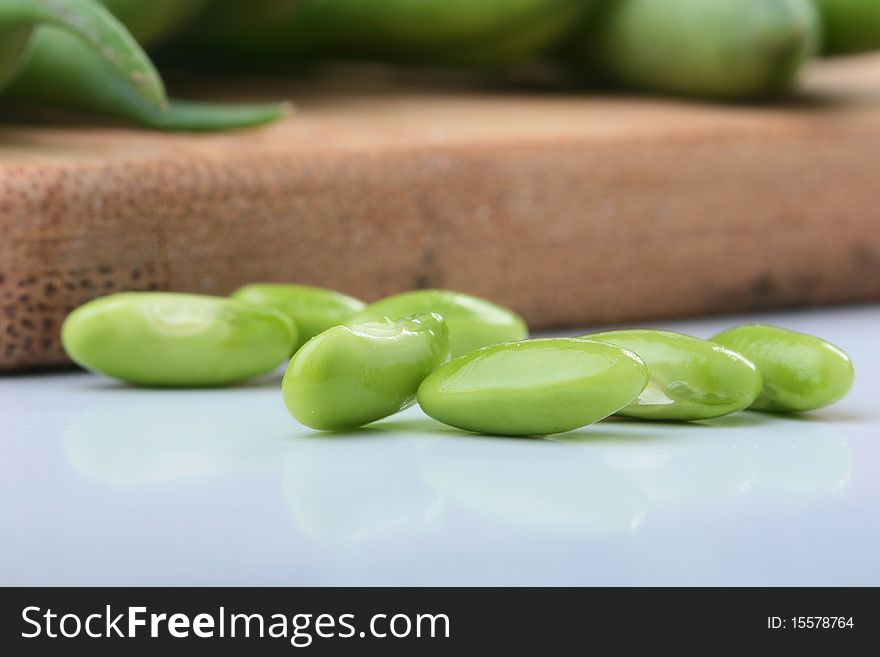 Vegetable kidney bean beans against on a kitchen board.