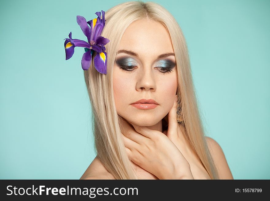 Beautiful blond in studio on the blue background. Beautiful blond in studio on the blue background