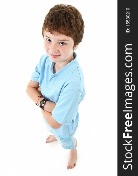 Handsome ten year old american boy standing over white background. Top view.