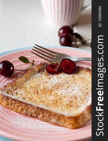 Toasted bread with cherries and powdered sugar