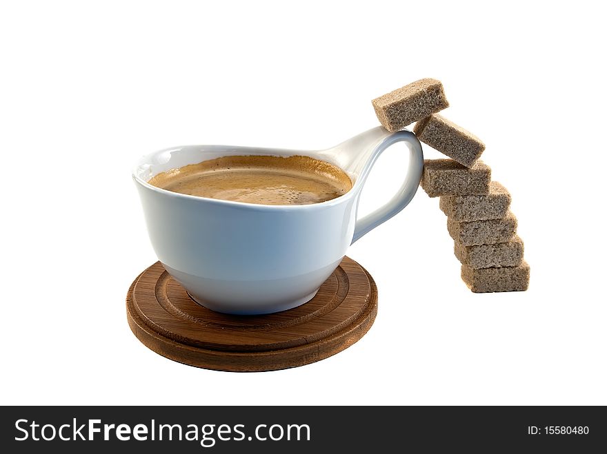 Brown sugar cubes jump into the cup of coffee