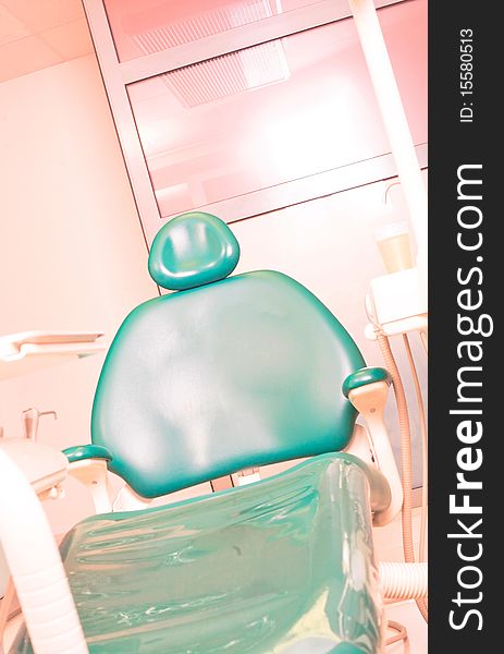 Green dentist chair in office. Green dentist chair in office