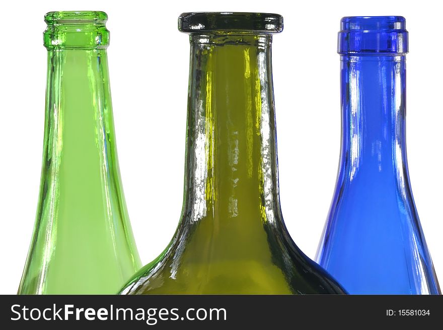 Three colored glass bottles against white background. Three colored glass bottles against white background