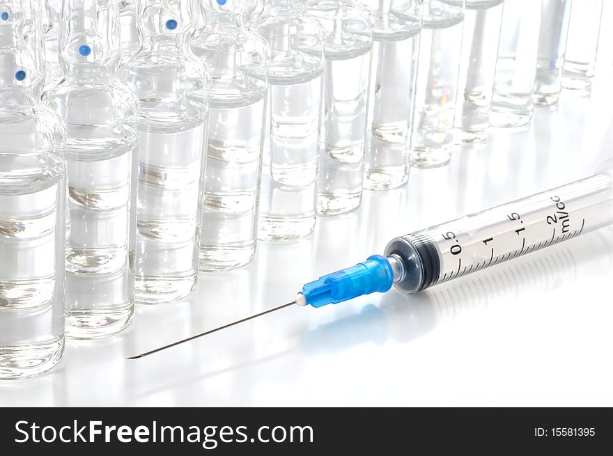 Single use syringe and vaccine against white background