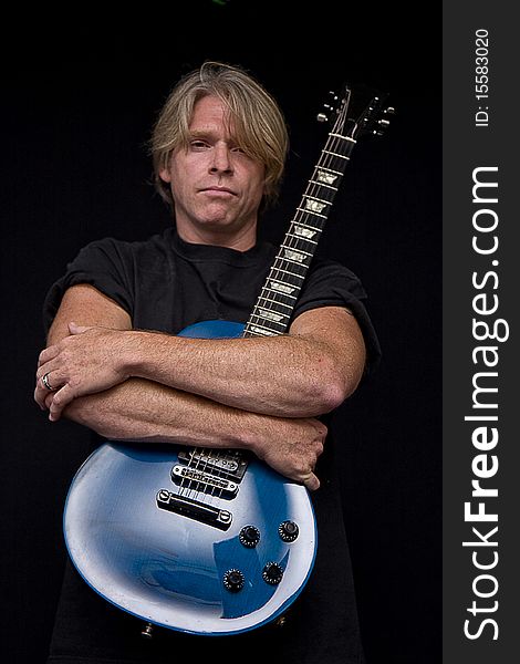 Rocker and his electric blue guitar. Rocker and his electric blue guitar