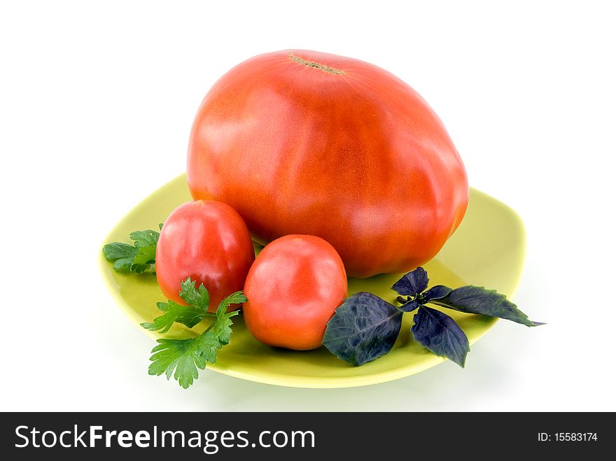 Big tomato with small tomatoes on plate