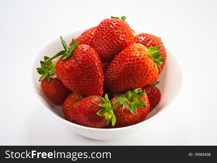 Strawberries in pot isolated on white