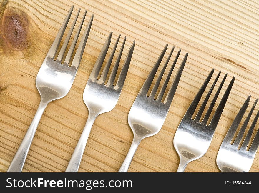 Background with silverware. Kitchen utensil on wood background. Background with silverware. Kitchen utensil on wood background