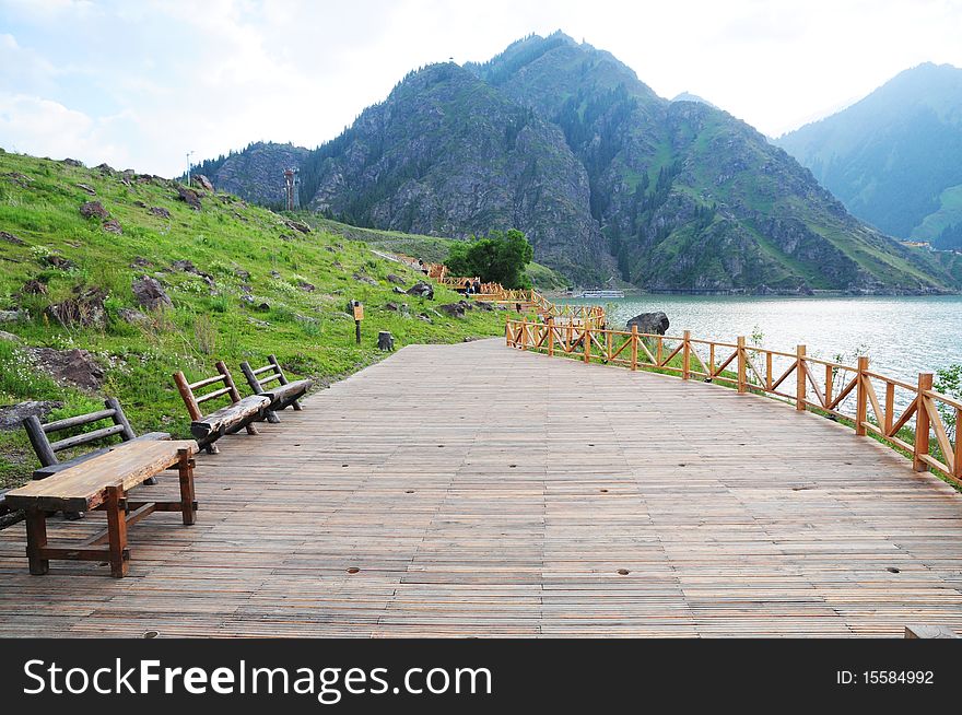 The long wood board pavement and wood benches by the mountain lake,Bogada Peak,Urumqi,Sinkiang,China. The long wood board pavement and wood benches by the mountain lake,Bogada Peak,Urumqi,Sinkiang,China.