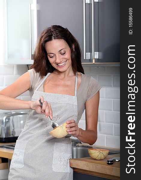 Woman In Kitchen Fixing Dinner