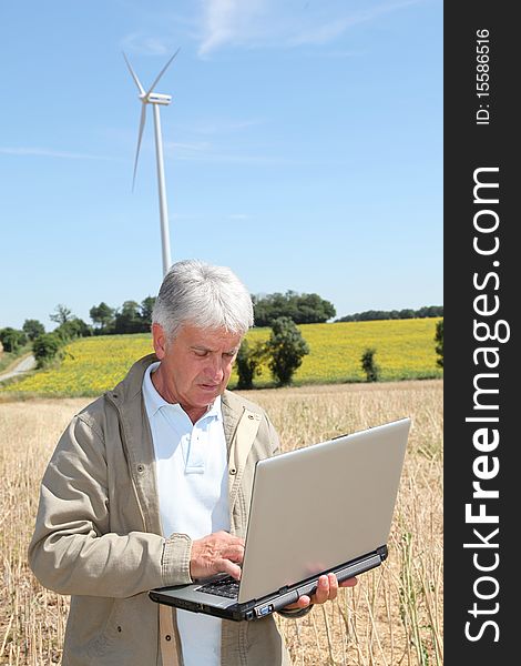 Agronomist in wheat field with laptop computer. Agronomist in wheat field with laptop computer