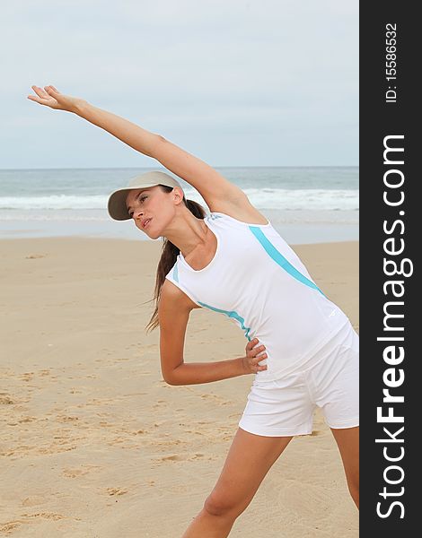 Woman doing exercises on the beach. Woman doing exercises on the beach