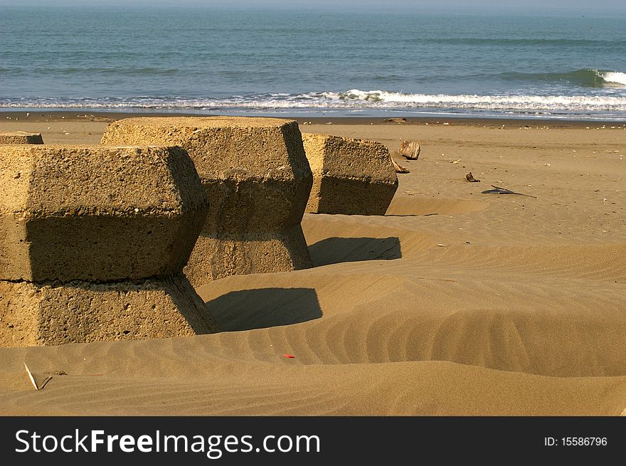 Three Wave Breakers on sandy beach