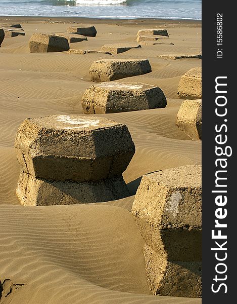 A shot of concrete wave breakers on beach