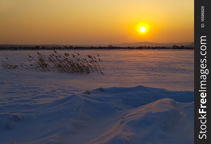 Sunset landscape in the field covered with snow. Sunset landscape in the field covered with snow