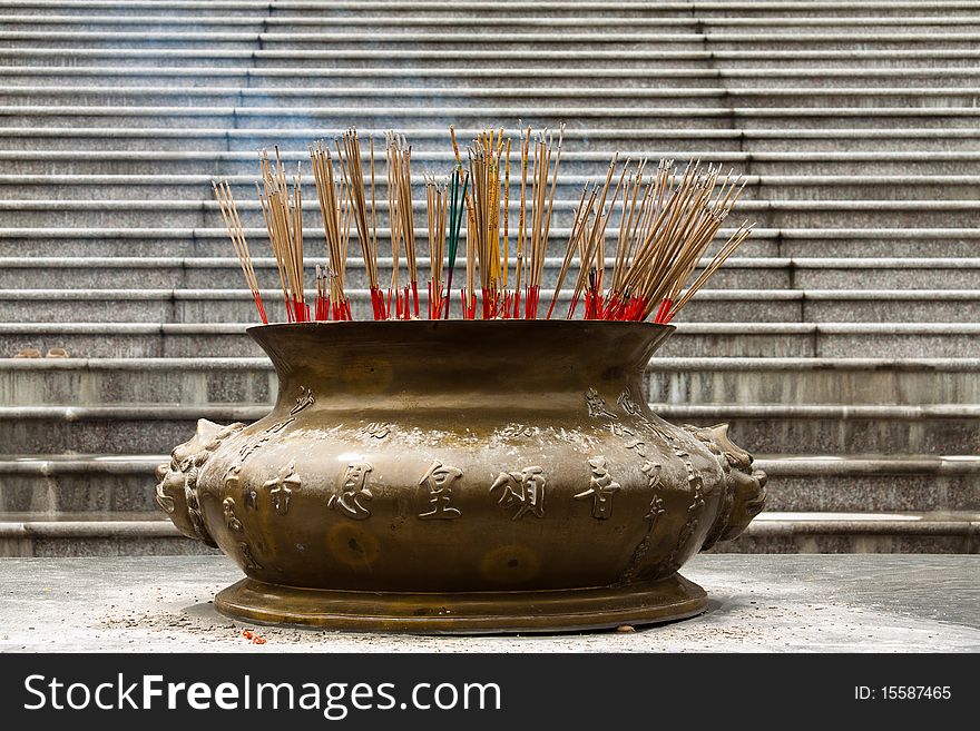 Brass incense burner in front of Chinese style temple
