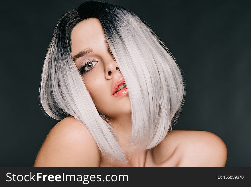 Naked fashionable girl posing in grey wig, isolated