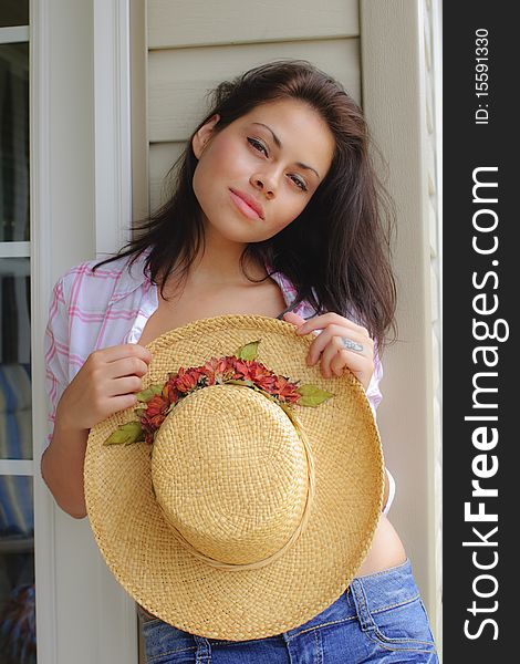 Beautiful young hispanic woman posing with hat. Beautiful young hispanic woman posing with hat