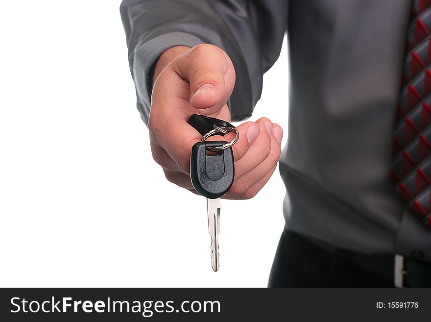 The businessman in a grey shirt and a tie stretches a car key. The businessman in a grey shirt and a tie stretches a car key.