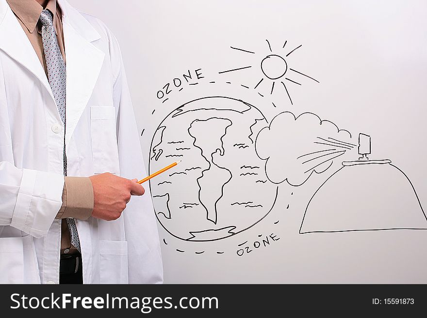 Man in a white lab coat pointing to a drawing of the earth being in danger. Man in a white lab coat pointing to a drawing of the earth being in danger.