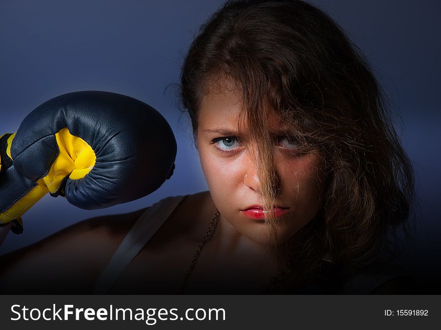 Young woman portrait with boxing glove. Young woman portrait with boxing glove