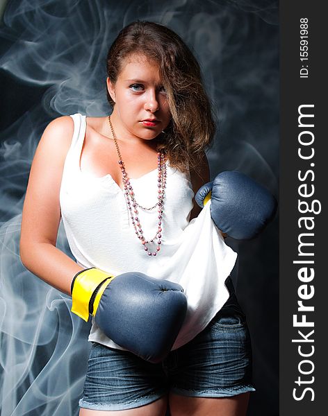 Young beautiful woman in boxing gloves. Young beautiful woman in boxing gloves