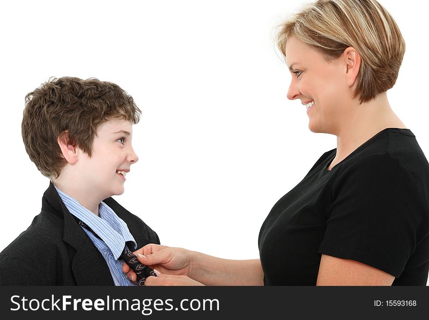 Mom helping adorable american 10 year old boy fix his tie in baggy over sized suit over white. Mom helping adorable american 10 year old boy fix his tie in baggy over sized suit over white.