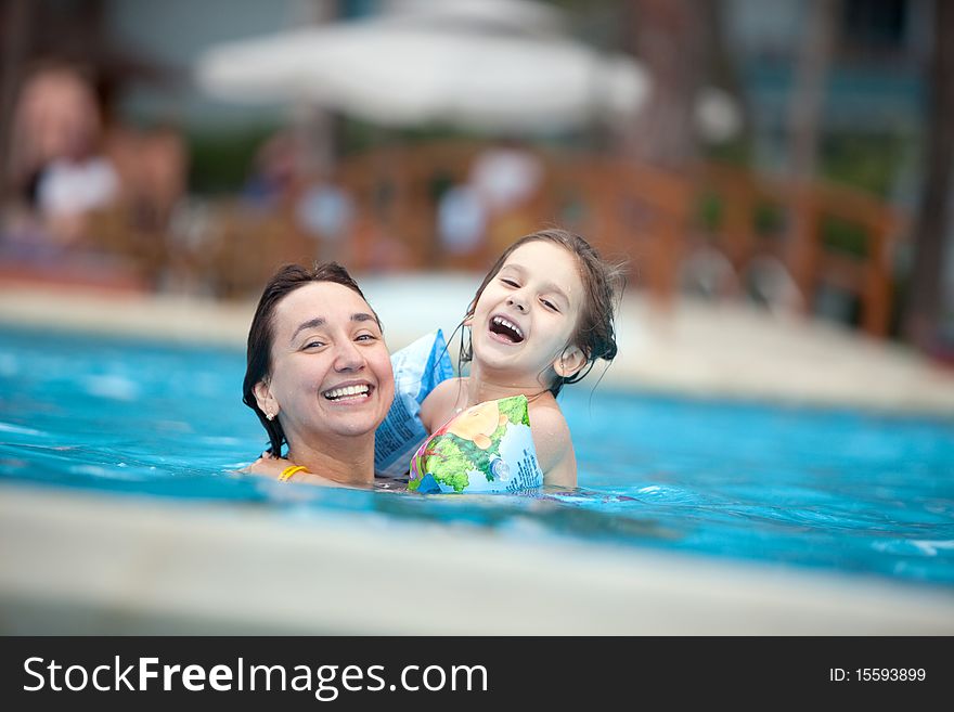 Mother and daughter in the swimming pool