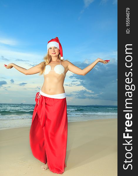 Miss Santa celebrates Christmas at the tropical beach. Miss Santa celebrates Christmas at the tropical beach