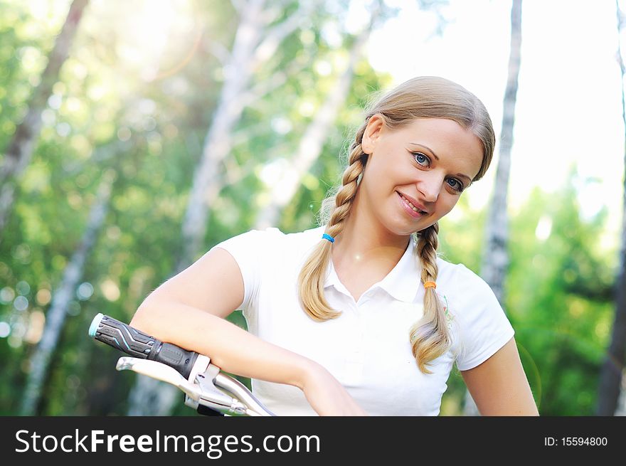 Young beautiful girl in a summer forest